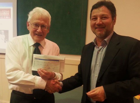 Mr. Julio Diaz Sevillano handing over a check donation of $800 to our treasurer Mr. Chris Corry.